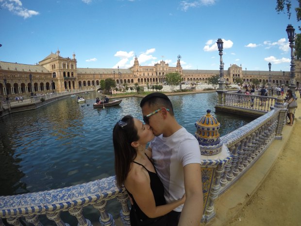 Kissing in front of Plaza de Espana in Sevilla, Spain